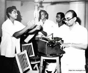 Kishore Kumar recording a song with Salil Chowdhury as Shailendra and Cawas